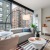 living room with large windows, a table with chairs and a couch